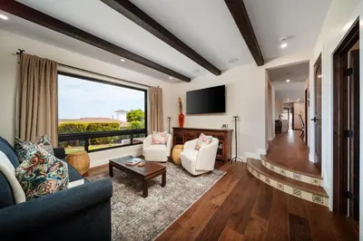 a living room with a couch and a tv at Luxury Point Loma Retreat Pool Spa Views in San Diego