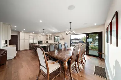 a kitchen and dining room with a wooden table and chairs at Luxury Point Loma Retreat Pool Spa Views in San Diego