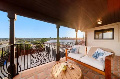 a balcony with a couch and a table at Luxury Point Loma Retreat Pool Spa Views in San Diego