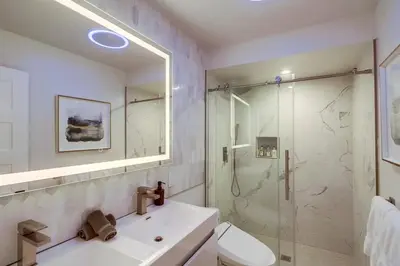 a bathroom with a shower and a toilet and a sink at Lux Escape 1 • Views Hot Tub Games Mini Golf in San Diego
