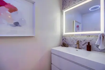 a bathroom with a sink and a mirror at Lux Escape 1 • Views Hot Tub Games Mini Golf in San Diego
