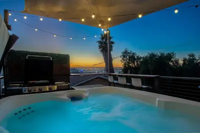 a jacuzzi tub with a view of the sunset at Lux Escape 1 • Views Hot Tub Games Mini Golf in San Diego