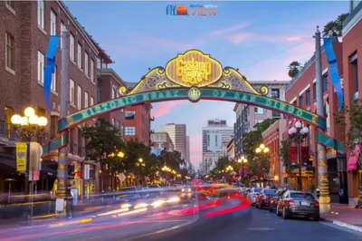 an arch over a city street with cars driving under it at Lux Escape 1 • Views Hot Tub Games Mini Golf in San Diego