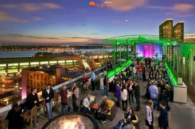 a crowd of people standing on the top of a building at Lux Escape 1 • Views Hot Tub Games Mini Golf in San Diego