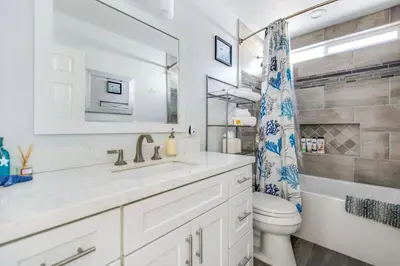 a bathroom with a sink and a toilet and a mirror at Relax Explore from Mission Viejo Pool Spa in Mission Viejo