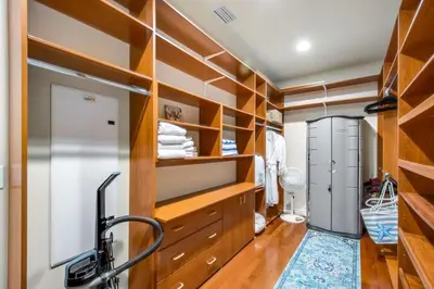 a dressing room with wooden shelves and a closet at Relax Explore from Mission Viejo Pool Spa in Mission Viejo