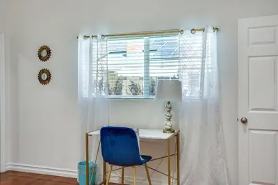 a desk with a blue chair next to a window at Relax Explore from Mission Viejo Pool Spa in Mission Viejo