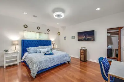 a bedroom with a blue bed and a table at Relax Explore from Mission Viejo Pool Spa in Mission Viejo