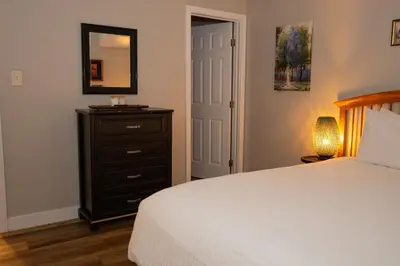 a bedroom with a bed and a dresser and a mirror at Beach Home in Quiet Neighborhood 5 minutes from the Pier in Oceanside