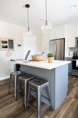 a kitchen with a counter with two stools and a counter top at Beach Home in Quiet Neighborhood 5 minutes from the Pier in Oceanside