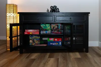a black cabinet filled with games and books at Beach Home in Quiet Neighborhood 5 minutes from the Pier in Oceanside