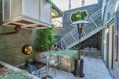a patio with a table and chairs and stairs at Hotel Narcissus - Room 1 in San Diego
