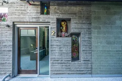 a brick building with a door with two stained glass windows at Hotel Narcissus - Room 1 in San Diego
