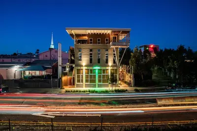 a building on the side of a street at night at Hotel Narcissus - Room 1 in San Diego