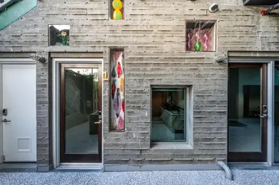 a wooden building with two windows and a door at Hotel Narcissus - Room 1 in San Diego