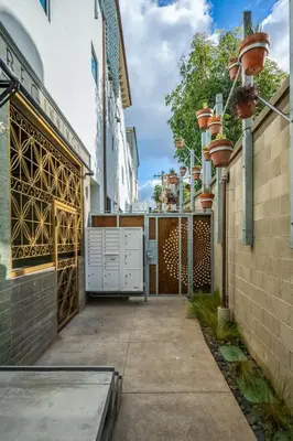 a walkway leading to a building with a gate at Hotel Narcissus - Room 2 in San Diego