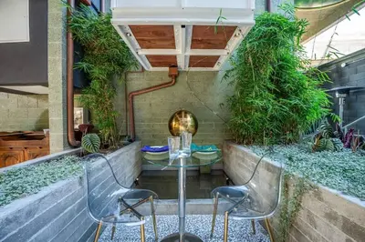a patio with a table and chairs and plants at Hotel Narcissus - Room 2 in San Diego