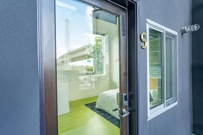 a door to a bedroom with a bed and a window at Hotel Narcissus - Room 2 in San Diego