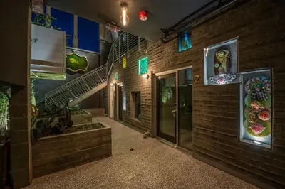 a hallway of a brick building with a staircase at Hotel Narcissus - Room 2 in San Diego