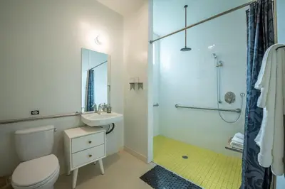 a bathroom with a toilet and a sink and a shower at Hotel Narcissus - Room 2 in San Diego