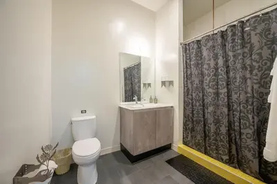 a bathroom with a toilet and a sink and a shower at Hotel Narcissus - Room 3 in San Diego