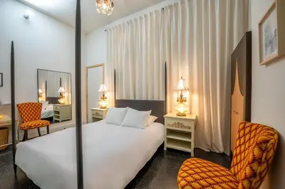 a hotel room with a bed and a chair at Hotel Narcissus - Room 4 in San Diego