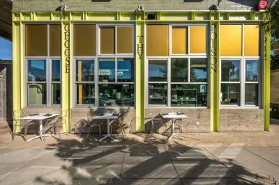 a group of tables in front of a building at Hotel Narcissus - Room 4 in San Diego