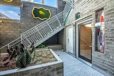 a building with a staircase next to a door at Hotel Narcissus - Room 4 in San Diego