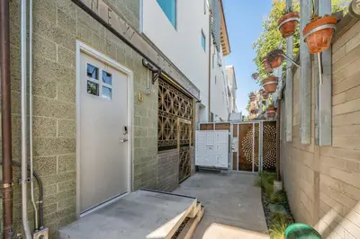 a hallway with a white door and a building at Hotel Narcissus - Room 4 in San Diego