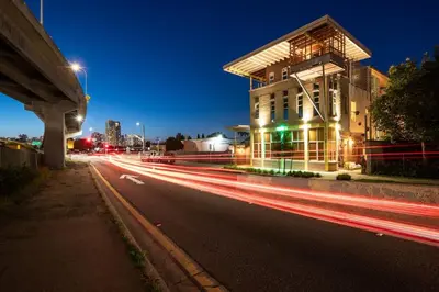 a city street with a building and streaks of lights at Hotel Narcissus - Room 4 in San Diego