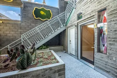 a building with a staircase next to a door at Hotel Narcissus - Room 5 in San Diego
