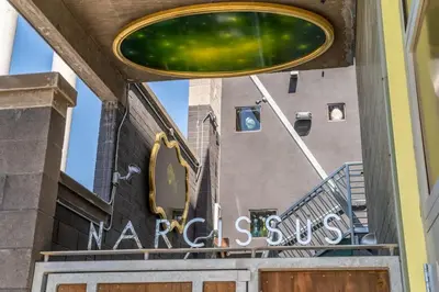 a sign for a market store in front of a building at Hotel Narcissus - Room 6 in San Diego
