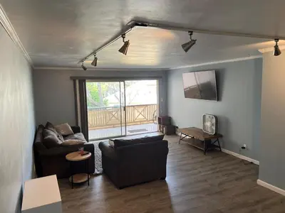 a living room with a couch and a table at Sunny Condo Steps from Sand in San Diego