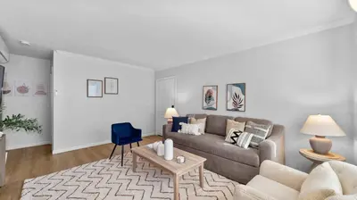 a living room with a couch and a blue chair at Stylish Apartments in Mission Hills with Outdoor Space in San Diego