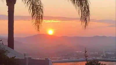 a sunset with a view of the mountains at San Diego Paradise - Scenic Views, Pool and Spa in El Cajon