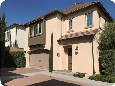 a large white house with a garage at Corporate Housing, Vacation Rental in Irvine in Irvine