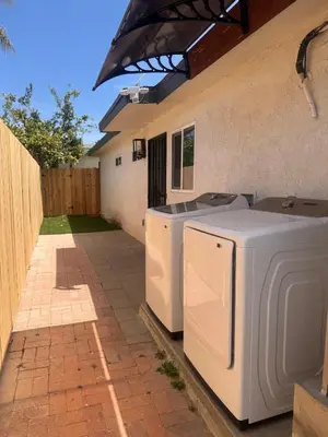 a patio with two washing machines sitting next to a house at Sea & Sun Getaway near Seaworld in San Diego
