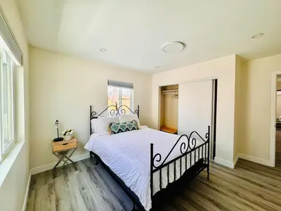 a bedroom with a black and white bed in a room at Sea & Sun Getaway near Seaworld in San Diego