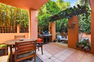 an outdoor patio with a table and a grill at La Jolla Gem Ocean Views Walk to Village Beach in San Diego