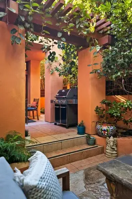 an outdoor patio with a grill and a table at La Jolla Gem Ocean Views Walk to Village Beach in San Diego
