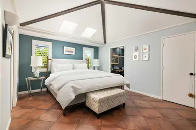 a bedroom with a large white bed and blue walls at La Jolla Gem Ocean Views Walk to Village Beach in San Diego