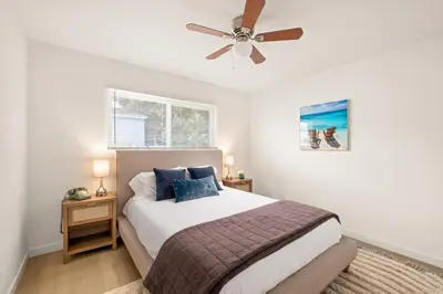 a bedroom with a bed and a ceiling fan at Relaxing 3BR Getaway in Central SD in San Diego