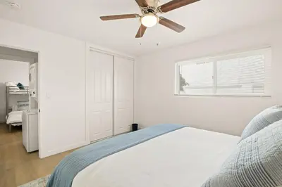 a bedroom with a bed and a ceiling fan at Relaxing 3BR Getaway in Central SD in San Diego