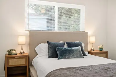 a bedroom with a large bed with two night stands at Relaxing 3BR Getaway in Central SD in San Diego