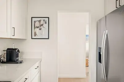 a kitchen with white cabinets and a refrigerator at Relaxing 3BR Getaway in Central SD in San Diego