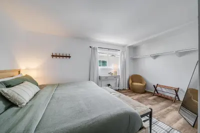 a bedroom with a bed and a desk and a window at Jewell Street Gems Two homes in one in San Diego