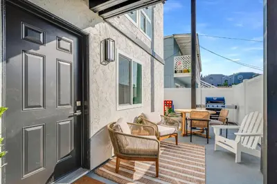 a door to a patio with chairs and a table at Jewell Street Gems Two homes in one in San Diego