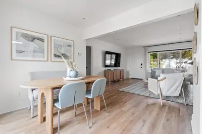 a dining room and living room with a table and chairs at NEW Cozy Modern Home with Hot Tub and Ocean Views in San Diego