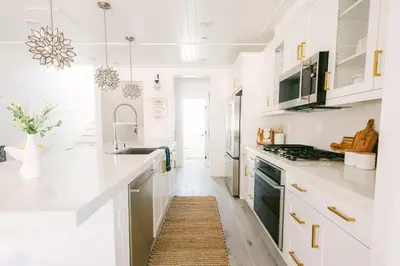 a white kitchen with white counters and a sink at Relaxing Mission Beach Getaway - 300ft to sand in San Diego