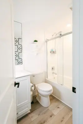 a white bathroom with a toilet and a shower at Relaxing Mission Beach Getaway - 300ft to sand in San Diego
